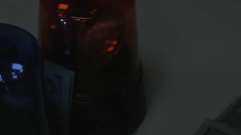 100 Dollar Bills Fall Onto Rotating Police Lights 4K Video stock 217855743
