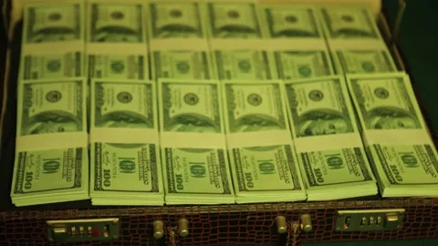 100-dollar notes filling the case, creating a sense of wealth and success. Stock Footage 230235824