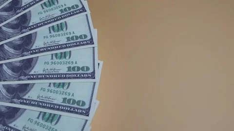100 dollars bills rotating on the table. Rotation of money. Top view, Copy space Vidéo 141927092