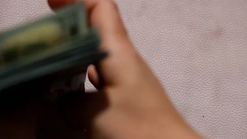 100 dollars bills on a table and debit card or Credit Card. This video is about Stock Footage 201602162