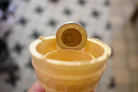 100 forint coin in an empty ice cream cone 写真素材