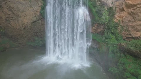 A 100-meter cliff surrounds the cave waterfall. Stock Footage 311742423
