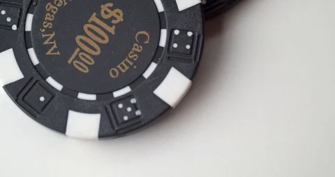$100 poker chip dropped onto another chip Stock Footage 112332153