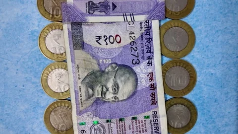 100 Rupee Indian Currency Note with Coins - Slider Shot - Backwards Video stock 276720416