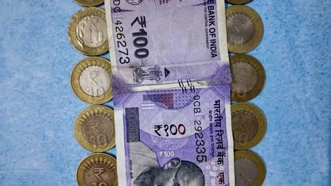 100 Rupee Indian Currency Note with Coins - Slider Shot - Forwards Stock Footage 276721872