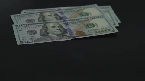 100 US dollar put on the black surface. Many bills of american money. Close up Video stock 132491954