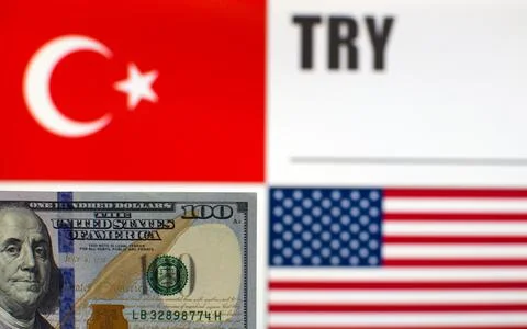 100 US dollars on blurred background of Turkey and USA flags Stock Photos
