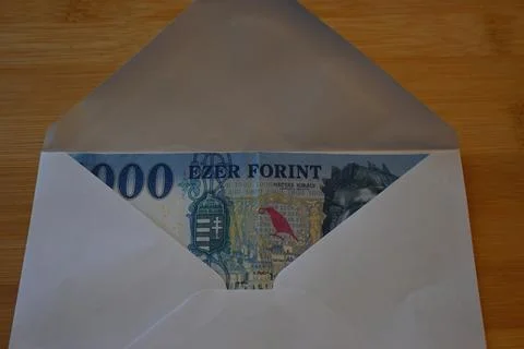 1000 forint banknotes in envelope on table Фото