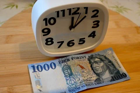 1000 forint coin with small clock on table 写真素材