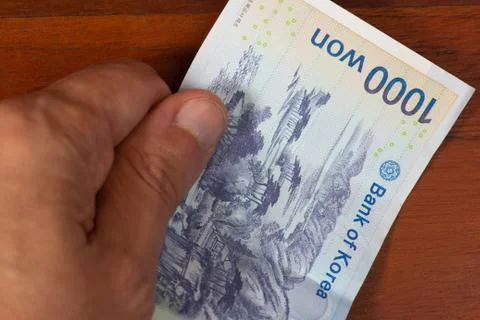 1000 won with a hand Stock Photos