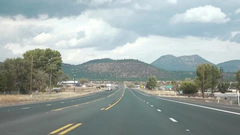 10/06/2024. Driving view on an open highway with mountainous backdrop Stock Footage 286204142