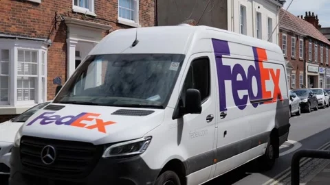 100fps at 50fps. FedEx delivery van in UK village. Hedon. UK 5.5.202 Stock Footage 335927798