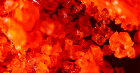 100x Microscopic View of Ammonium Dichromate (NH4)2Cr2O7 Crystals Stock Footage 303630644