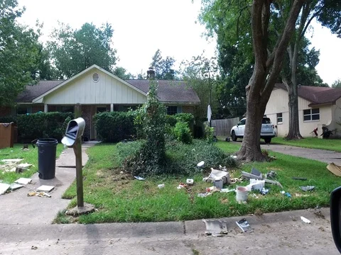 10/10/17 Dickinson, TX: Trash and debris on the streets of a flooded home Stock Footage 80921702