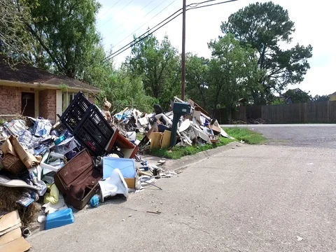 10/10/17 Dickinson, TX: Trash and debris on the streets of a flooded home Stock Footage