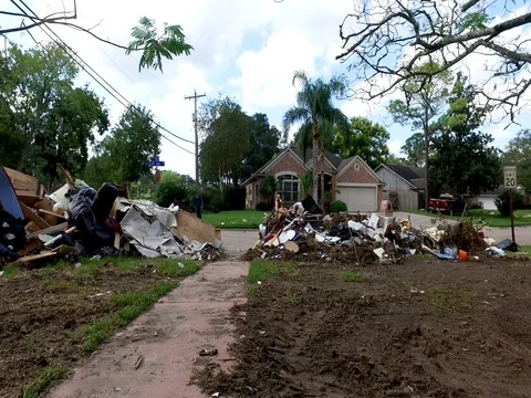 10/10/17 Dickinson, TX: Trash and debris on the streets of a flooded home Stock Footage 80922581