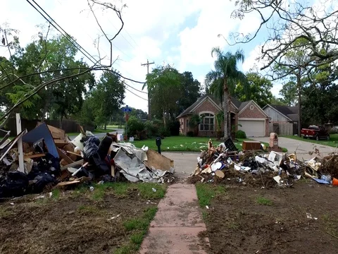 10/10/17 Dickinson, TX: Trash and debris on the streets of a flooded home Stock Footage 80924792