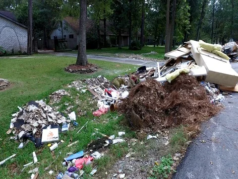 10/10/17 Dickinson, TX: Trash and debris on the streets of a flooded home Stock Footage 80933752