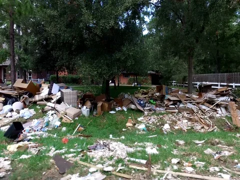 10/10/17 Dickinson, TX: Trash and debris on the streets of a flooded home Stock Footage 80934094
