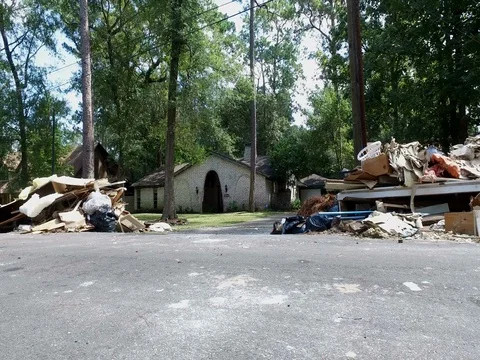 10/10/17 Dickinson, TX: Trash and debris on the streets of a flooded home Stock Footage 80934140