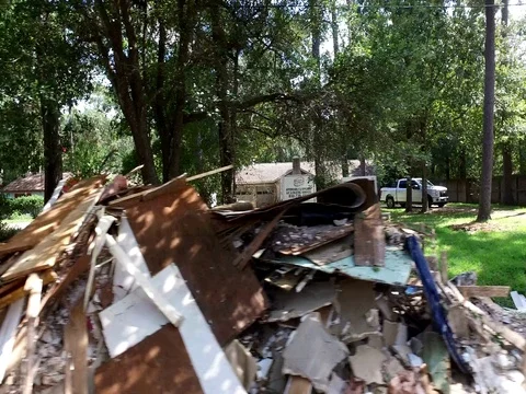 10/10/17 Dickinson, TX: Trash and debris on the streets of a flooded home Stock Footage 80934197
