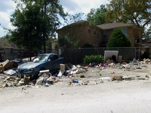 10/10/17 Dickinson, TX: Trash and debris on the streets of a flooded home Stock Footage 80934276