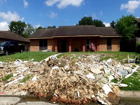 10/10/17 Dickinson, TX: Trash and debris on the streets of a flooded home Stock Footage 80934420