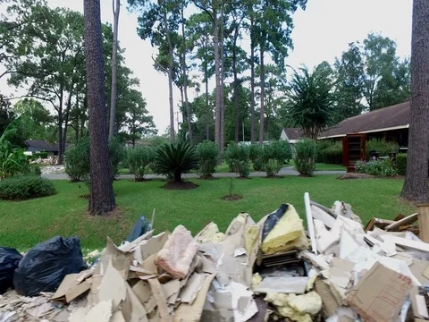 10/10/17 Dickinson, TX: Trash and debris on the streets of a flooded home Stock Footage 80934477