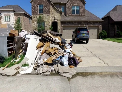10/10/17 Dickinson, TX: Trash and debris on the streets of a flooded home Stock Footage 80934587