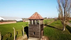 Drone rising next to a guard tower in Auschwitz Birkenau, Poland, Europe