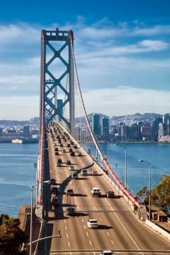 SAN FRANCISCO - NOVEMBER 2012: The Bay Bridge on November 3rd, 2012 in San Francisco, USA. The Bay Bridge was opened for traffic on November 12, 1936 and carries approximately 270,000 vehicles per day on its two decks. It has one of the longest spans in the world. xkwx america, american, architecture, area, attraction, bay, beauty, blue, bridge, building, cable, california, cars, city, cityscape, connection, construction, crossing, downtown, famous, francisco, historic, island, landmark, landscape, monument, oakland, ocean, pacific, panorama, port, river, road, san, sea, sf, skyline, span, states, steel, structure, suspension, tourism, tower, traffic, transportation, travel, united, usa, water