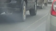 Cars in traffic. Exhaust fumes from exhaust pipe