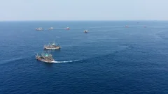 Industrial Overfishing - aerial view of fishing trawlers operating at sea