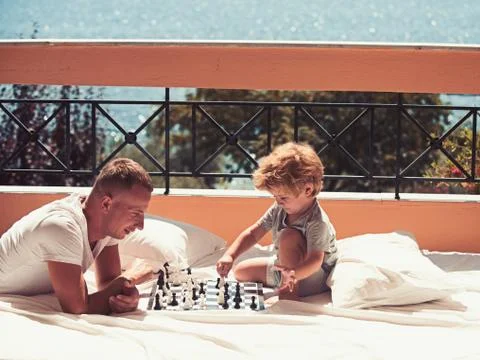 Love and trust as family values. Family travel with kid on fathers day. Summer vacation of happy family. Child play chess with father. father with son on balcony play chess. xkwx family, chess, father, son, love, vacation, happy, balcony, travel, sea, beach, play, education, game, checkers, terrace, hotel, trust, values, adorable, boy, holiday, family life, young, family vacation, idyllic, cute, happiness, wanderlust, ecology, nature, family summer, traveling, lifestyle, bermudas, little, mediterranean, youth, family travel, trip, kid, small, childhood, family holiday, Bahamas, family relations