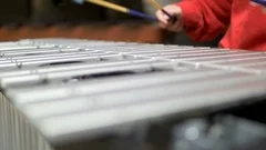 Musician hands playing the vibraphone in red outfit