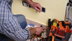 Electrician technician at work on a residential electric system.