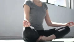 Female hands during yoga meditation in lotus pose in studio rapid slow motion