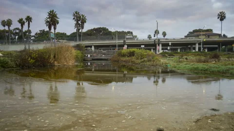 1080p Sunrise time lapse runoff beach water near freeway in California Stock Footage 55548053