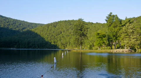 1080p time-lapse of sun setting shadow on Sherando Lake in Virginia Stock Footage 262714