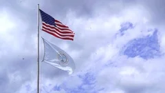American flag and Virginia Beach flag in the wind
