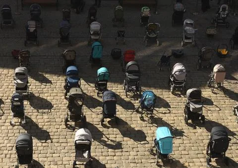 109 empty strollers an action to highlight the number of killed children Stock Photos