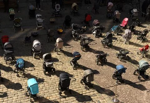 109 empty strollers an action to highlight the number of killed children Stock Photos