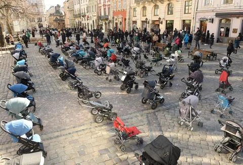 109 empty strollers an action to highlight the number of killed children Stock Photos