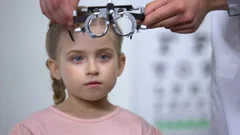 Optometrist putting special glasses on little girl, diagnosing Lazy eye illness