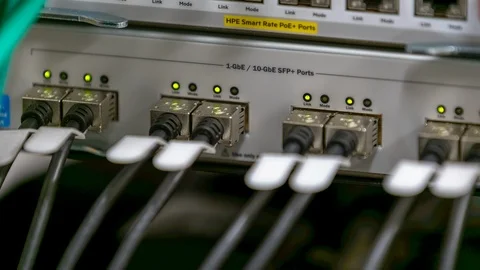 10G-bE fiber optic patch cords plugged into a switch / router with SFP+ Stock Footage 122056548