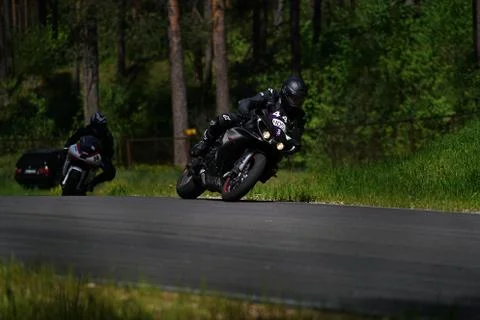 11-05-2020 Riga, Latvia Motorcyclist at sport bike rides by empty asphalt roa 库存照片