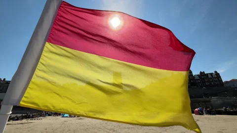 11 august 2026 Backlit Swimming Flags at Cromer on Norfolk coast - UK Stock Footage 342559917