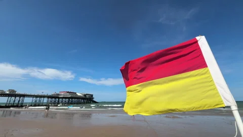 11 august 2026 Swimming Flags at Cromer Pier on Norfolk coast - UK Stock Footage 342559979