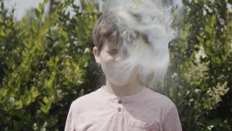 11 year old boy being hit in head by water balloon in super slow-motion Stock Footage 127543742