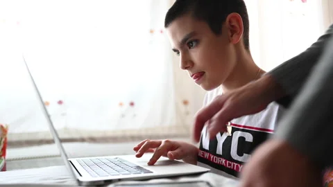 11 year old boy studying at home with the help of his mother Video stock 130331057